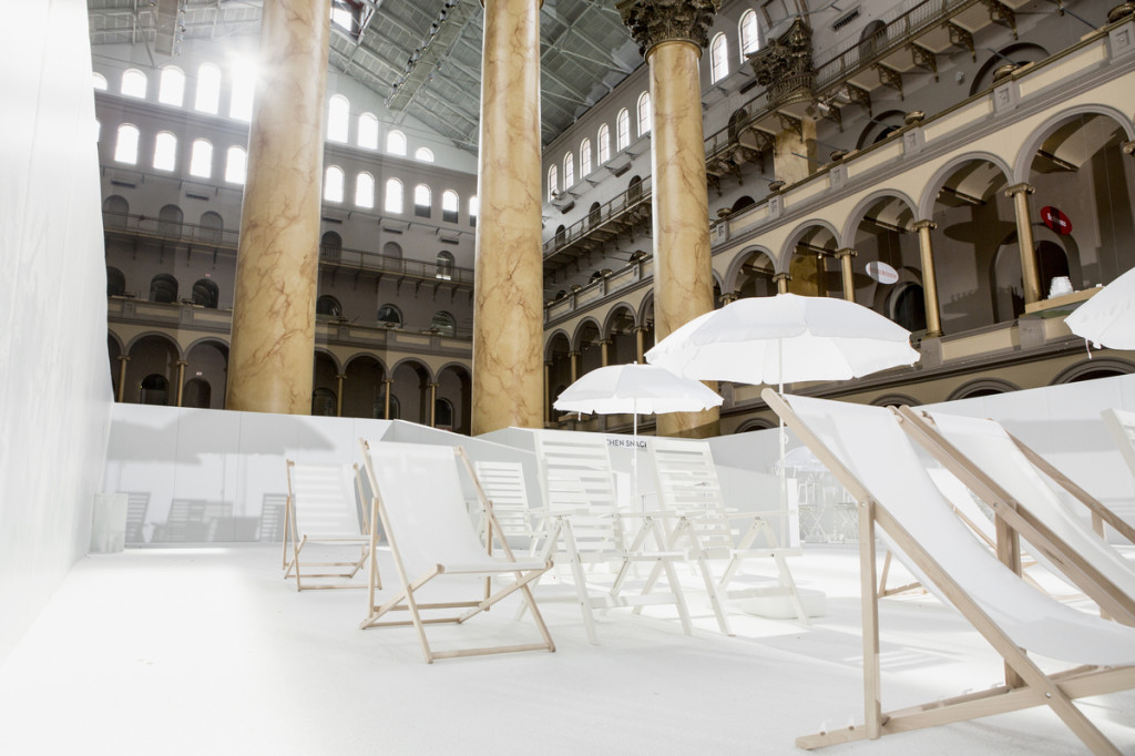 The exhibition includes lounge chairs and 700,000 white plastic orbs in the museum's Italian Renaissance style building.