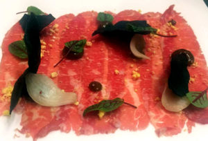 Waygu beef carpaccio with black garlic aioli and roasted cippolini onions