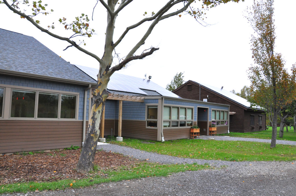 A photo of the single story Community with solar panels on the roof