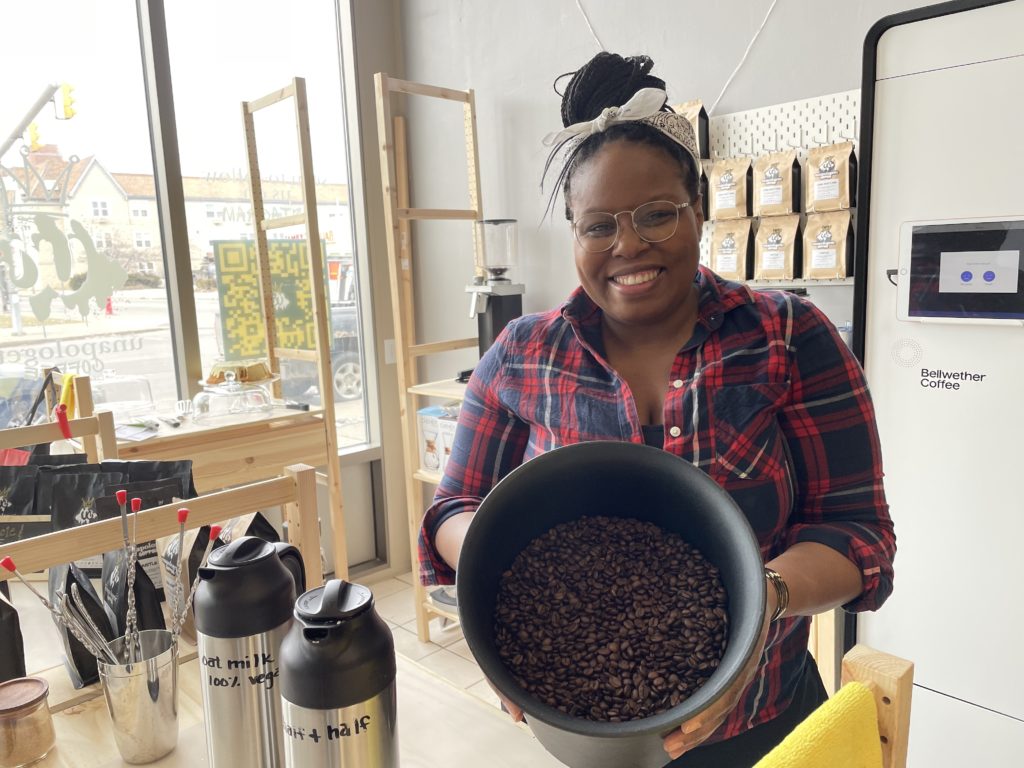 Photo of Alisa holding up coffee beans