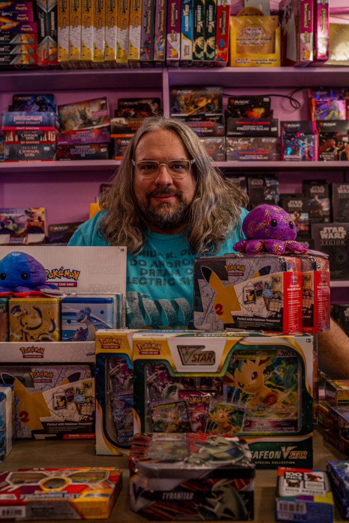 Gather and Game owner shows some of the Pokemon merchandise they sell