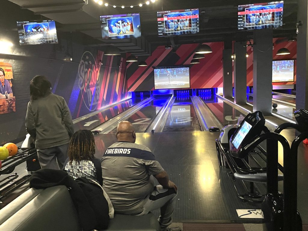 Photo of the family of three bowling