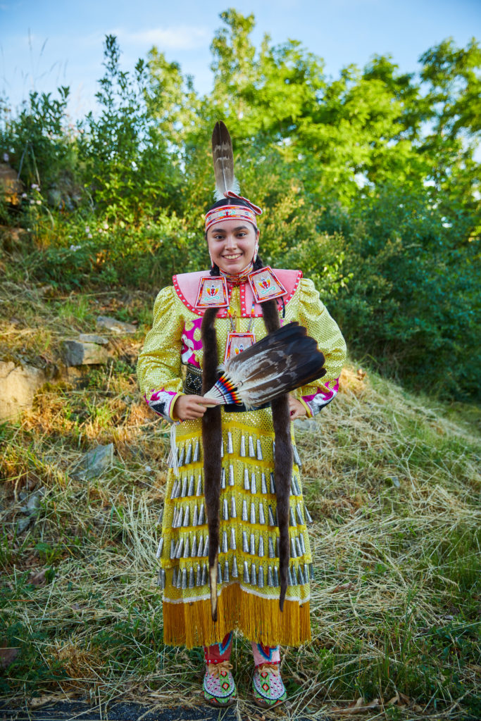 A Native American woman in traditional outfir for the Strawberry Moon festival