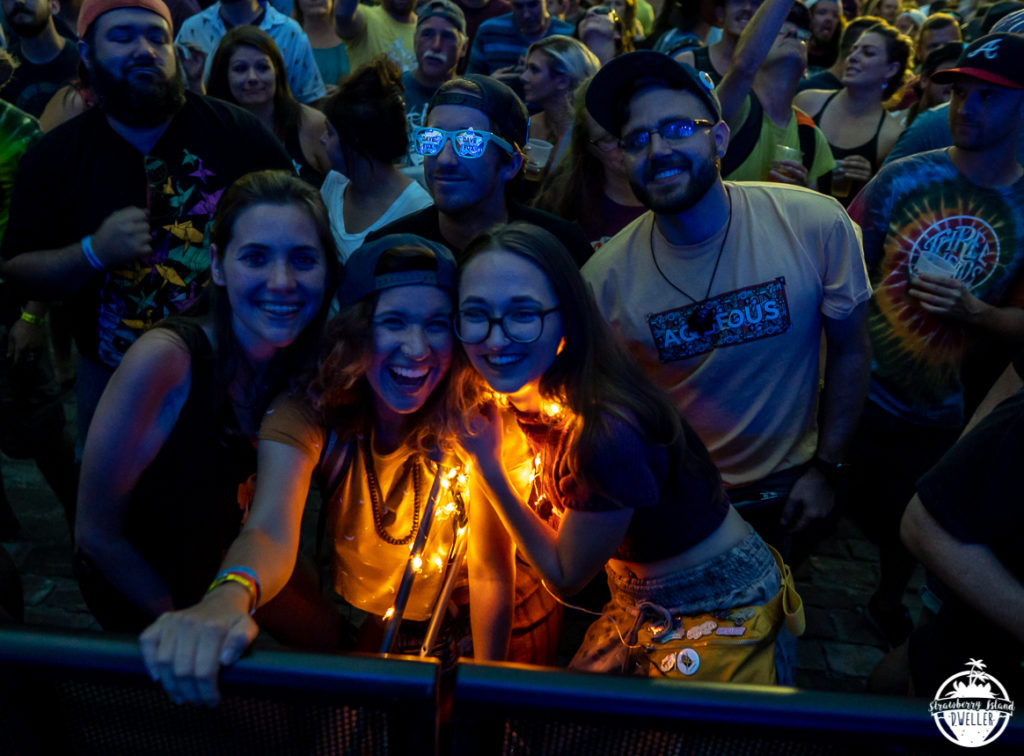 A group of friends smiling as they enjoy one of the concerts at Cobblestone Live 