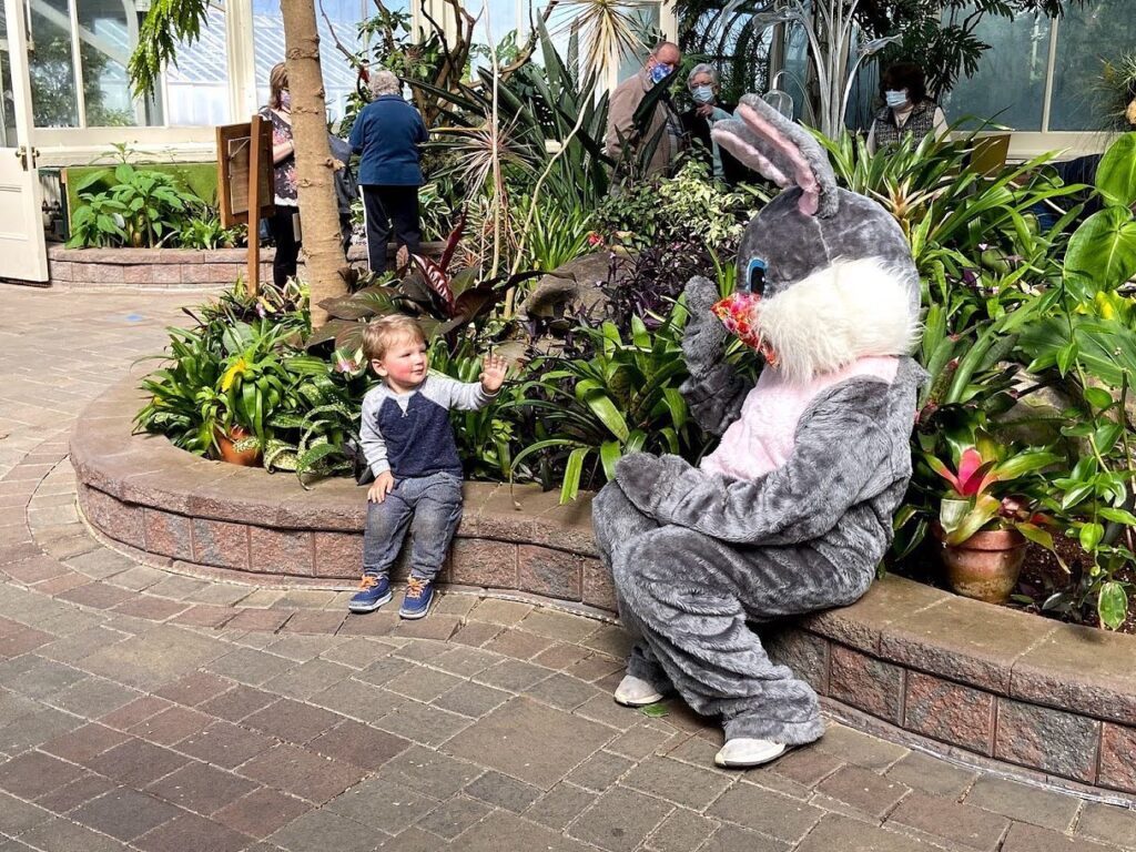 The Easter bunny encounters a young patron at the Buffalo and Erie County Botanical Gardens