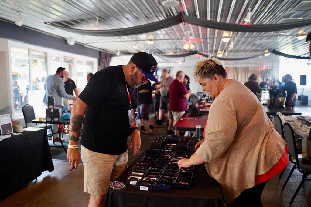 A vendor shows some of her cigar related wares at the Buffalo Cigar Festival